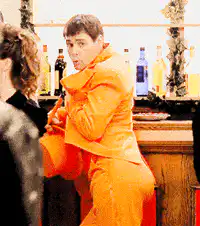 Man in orange suit dancing at bar