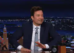 Jimmy Fallon talking at his desk