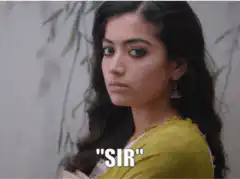Woman in yellow looking serious saying sir