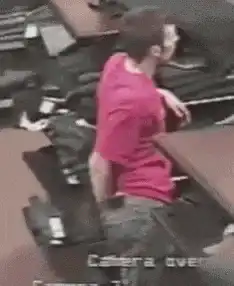 Man in pink shirt looking at phone