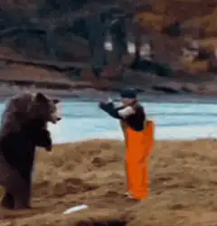 Man in orange pants fighting a bear