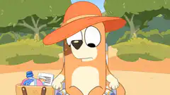 Bluey wearing a hat with a picnic basket