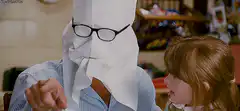 Man with paper bag on head and girl