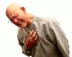 Bald man clutching chest in pain