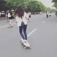 Girl skateboarding and laughing