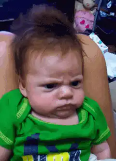 Baby with messy hair looking confused