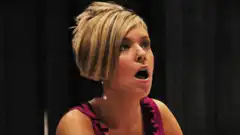 Woman with short blonde hair looking shocked