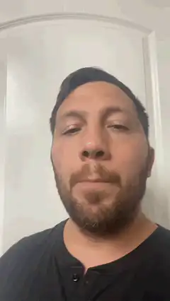 Man blinking and pursing lips
