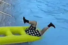 Person falling off yellow pool float