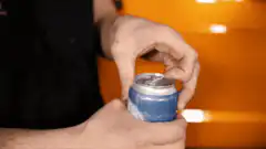 person opening a soda can