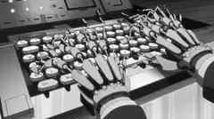 robot hands typing on keyboard