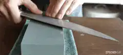 Sharpening a knife on a whetstone