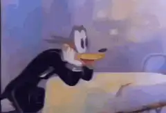 Daffy Duck sliding across a table