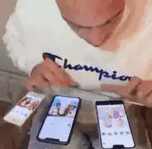 man multitasking on three phones