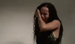Woman crying and covering face