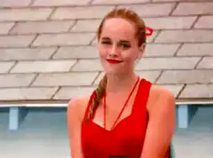 Emma Stone waves with sparkles