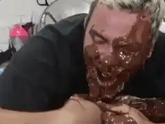 man covered in chocolate licking hands
