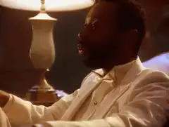 Tommy Davidson in white suit talking
