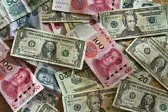 US dollars and Chinese yuan banknotes