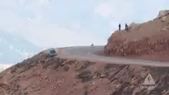 Car rolls down steep hillside