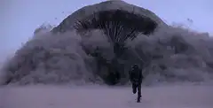 Man running from giant sandworm