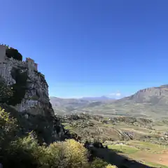 castle on cliff overlooking valley