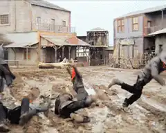 cowboy shooting log in western town