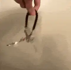 Hand swinging a rosary