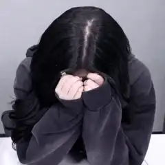 Woman crying with hands over face