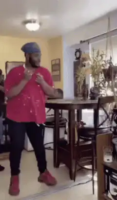 Man in pink coat dances and poses