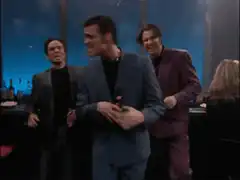 Three men laughing at a bar