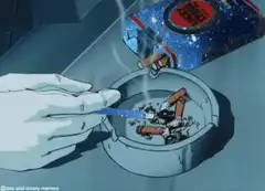 Hand holding cigarette over ashtray