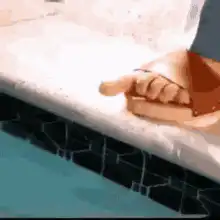Hand dipping sausage in pool