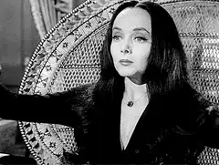 Morticia Addams doing magic