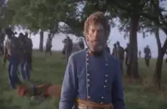 Confederate officer looks on at battlefield