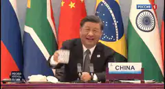 Xi Jinping holds up a die