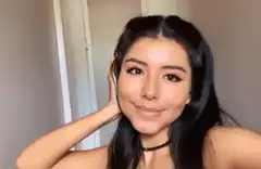 Woman smiling and touching hair