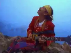 Man playing guitar on a cliff