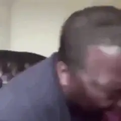 Man laughing hysterically on couch