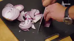 Slicing red onion on cutting board