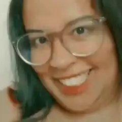 Woman with glasses smiling and widening eyes