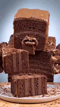 Hands pulling apart chocolate cake