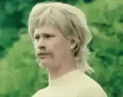 Man with mustache looking around confused