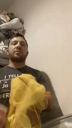 man wiping face with yellow cloth
