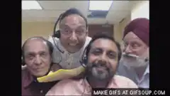 Indian men laughing and clapping