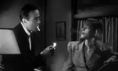Humphrey Bogart and Lauren Bacall smoking
