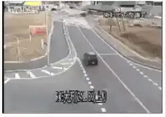 Tsunami hits road with car