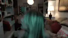 Girl with green hair whipping her head