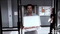 Dexter holding a box of donuts
