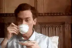 Man sips tea and smiles